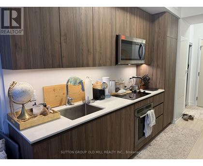 A kitchen with wooden cabinets and a white countertop.