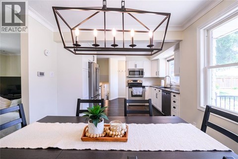A modern kitchen with a dining table set for two.