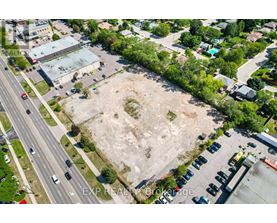 An aerial view of a parking lot and a road with cars.