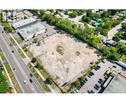 An aerial view of a parking lot and a road with cars.