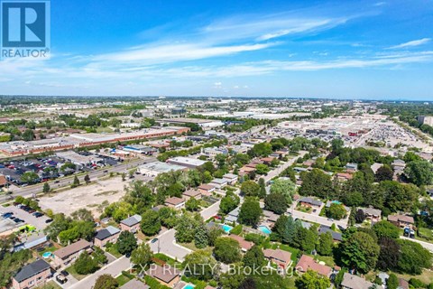An aerial view of a residential area with a clear blue sky above.