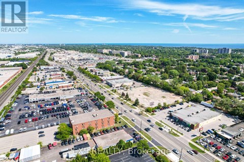 A bird's eye view of a parking lot with a clear blue sky above.