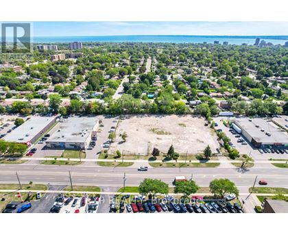 A bird's eye view of a parking lot with cars and a road.
