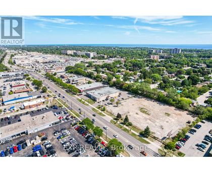 A bird's eye view of a parking lot with a clear blue sky in the background.