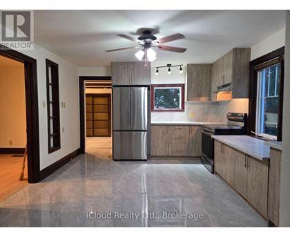 A modern kitchen with a refrigerator, stove, and oven.
