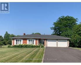 A house with a red brick chimney and a white garage door.
