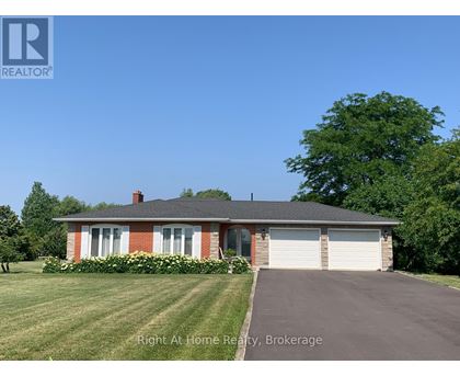 A house with a red brick chimney and a white garage door.