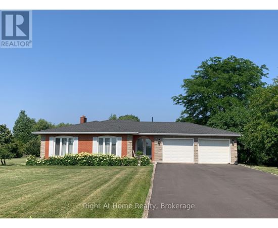 A house with a red brick chimney and a white garage door.