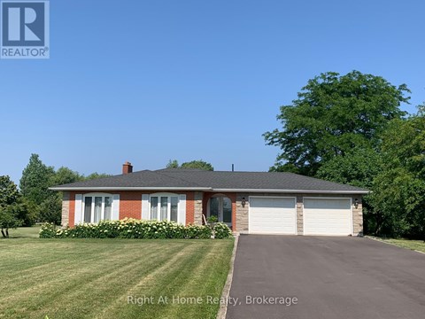 A house with a red brick chimney and a white garage door.