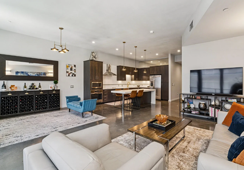 A modern living room with a white couch and a coffee table.