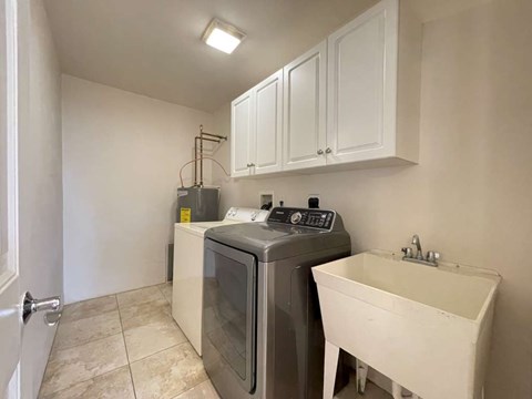 A small laundry room with a washer and dryer.
