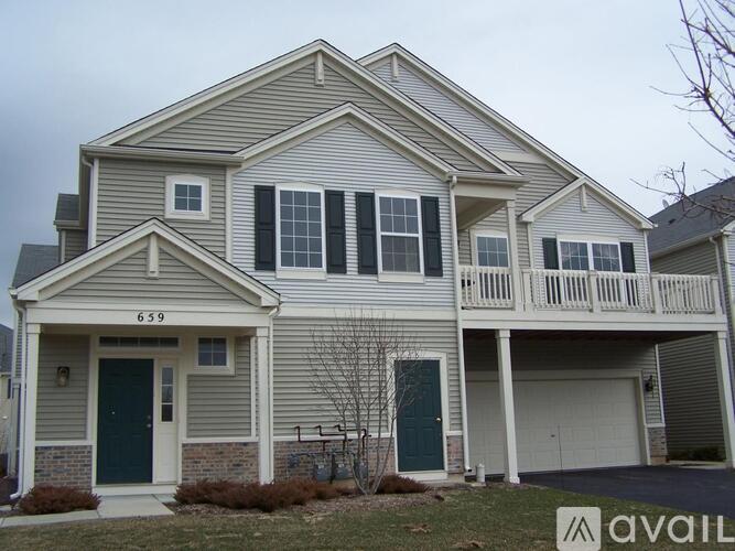 A two-story house with a garage on the lower level.