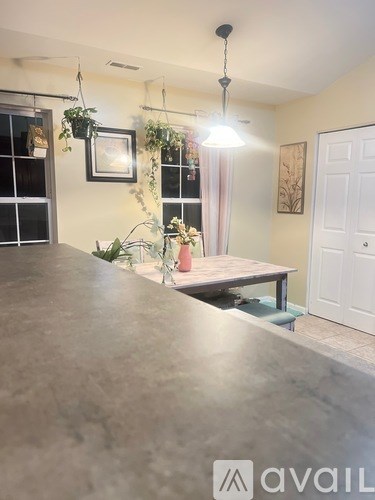 A dining area with a table and chairs is shown.