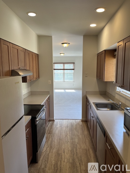 A kitchen with wooden cabinets and a white refrigerator.