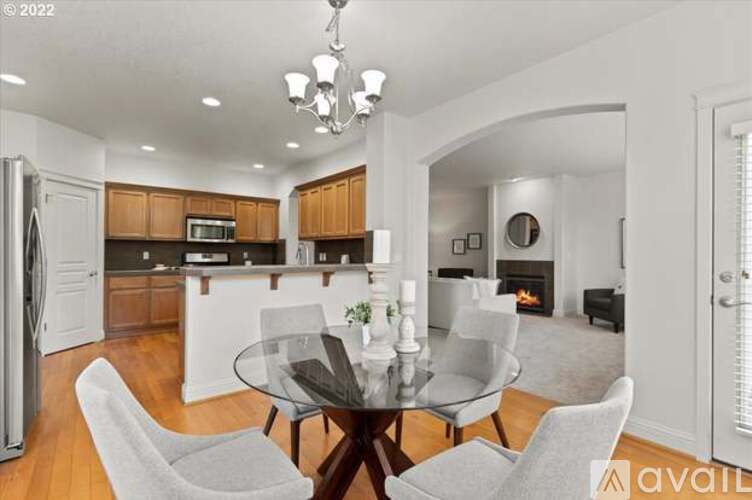 A modern kitchen with a dining table set for four.