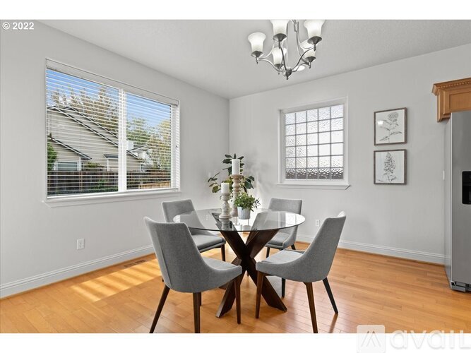 A dining room with a glass table and chairs.