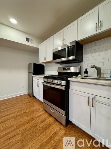 A kitchen with white cabinets and stainless steel appliances.