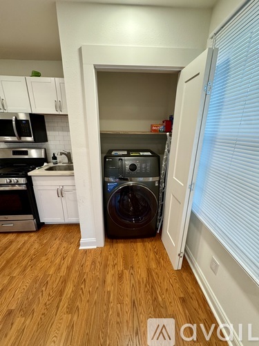 A small laundry room with a washer and dryer.