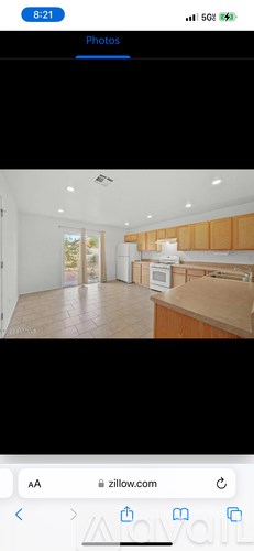 A photo of a kitchen with wooden cabinets and a white refrigerator.