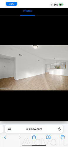 A white room with wooden flooring and white walls.