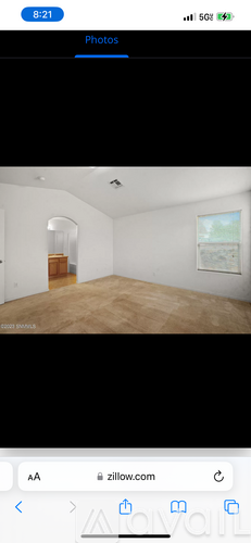 A room with a wooden floor and white walls.