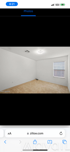 A room with white walls and a window.