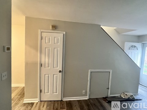 A room with a white door and a window.