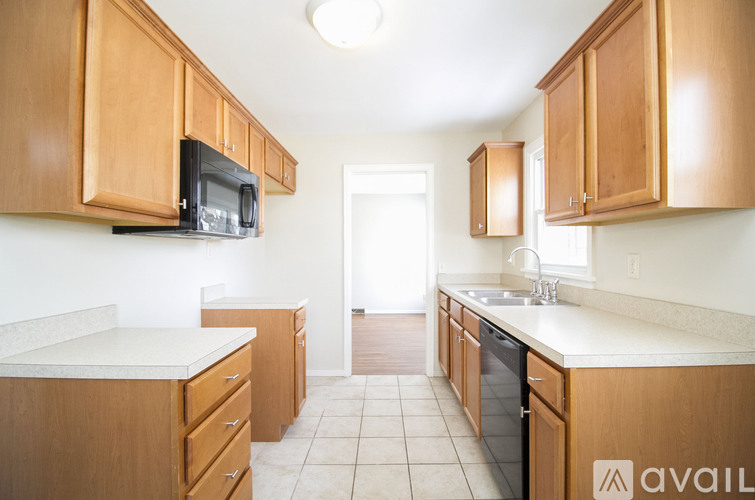 A kitchen with wooden cabinets and a white countertop.