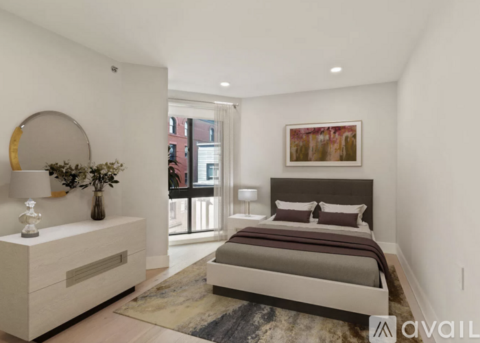 A bedroom with a large bed and a painting on the wall.