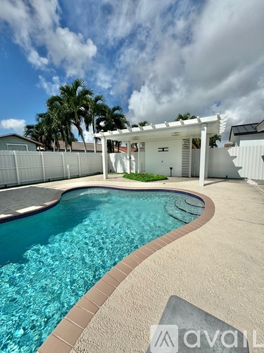 A pool with a white building in the background.