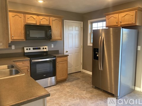 A kitchen with a stainless steel refrigerator and oven.
