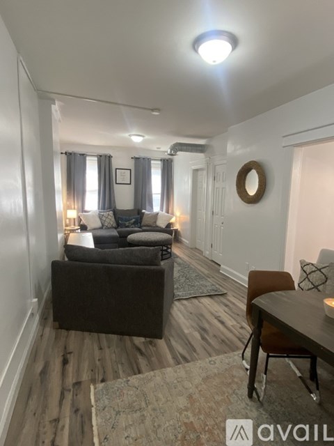A living room with a grey couch and a brown chair.