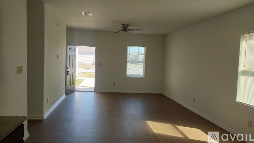 A spacious room with a ceiling fan and a window.