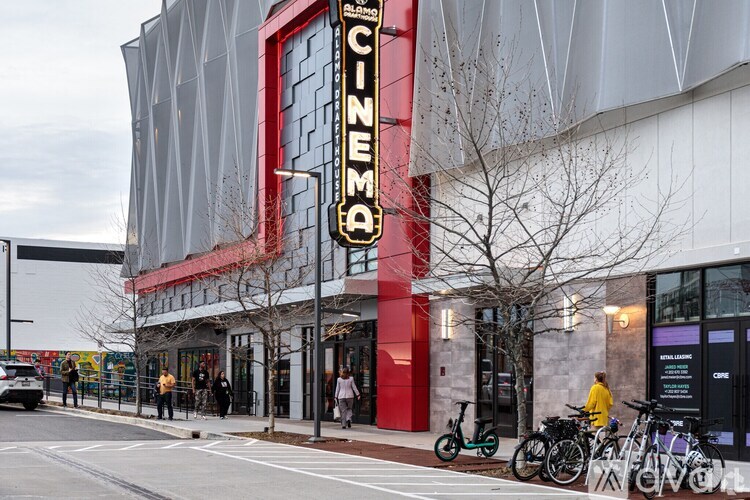 A cinema building with a red and black signboard.