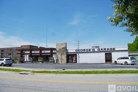 George's Garage is a white building with a sign on top.