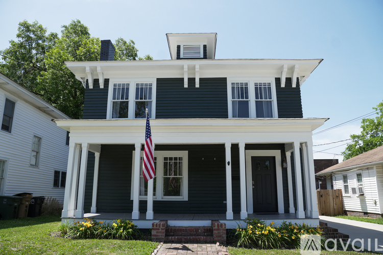 A house with a flag on the porch.