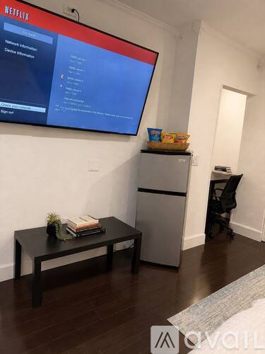 A living room with a Netflix screen on the wall.