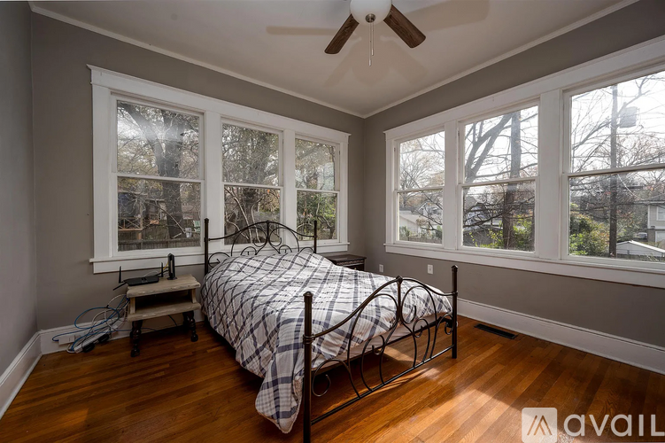 A bedroom with a bed and a window.