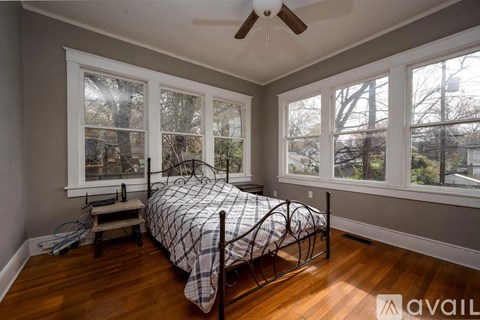 A bedroom with a bed and a window.