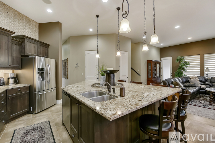 A kitchen with a marble countertop and a sink.
