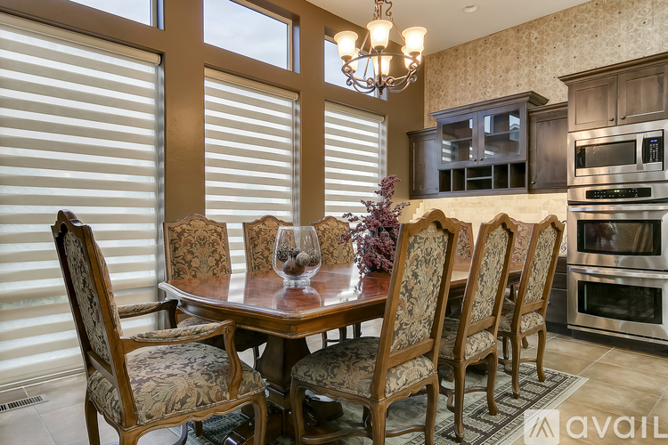 A dining room with a table set for four.