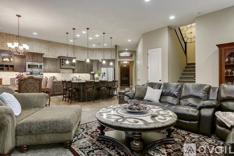 A living room with a large table and a couch.