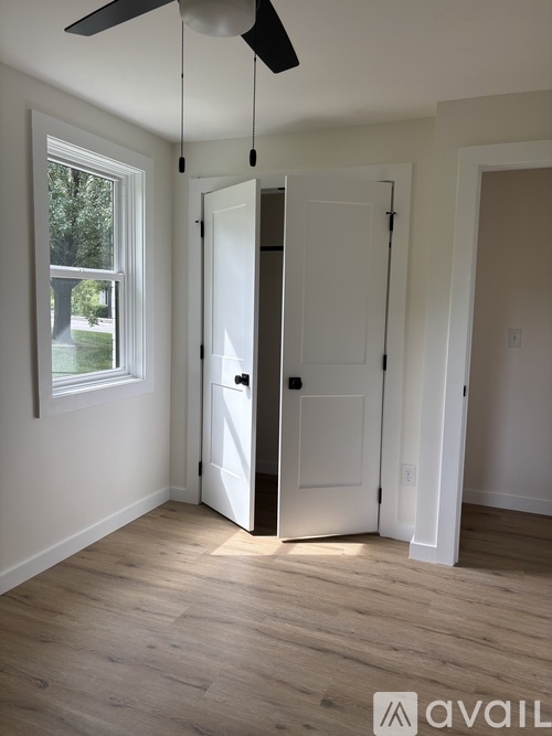 A room with a white door and a window.