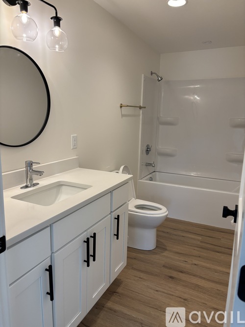 A bathroom with a white sink, toilet and bathtub.