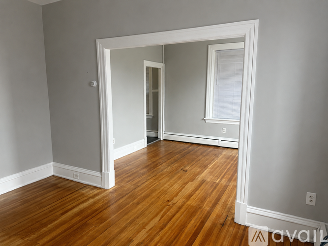 A room with wooden floors and white walls.