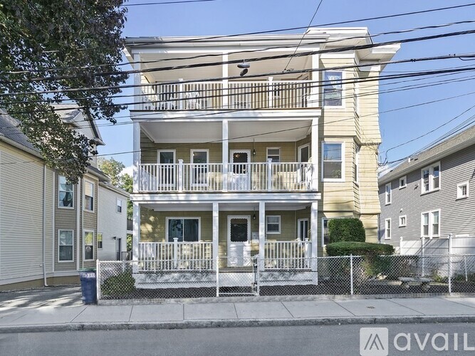 A two-story building with a balcony is available for rent.