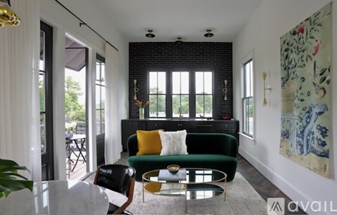 A living room with a green couch and a coffee table.