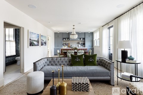 A modern living room with a grey sofa and a coffee table.