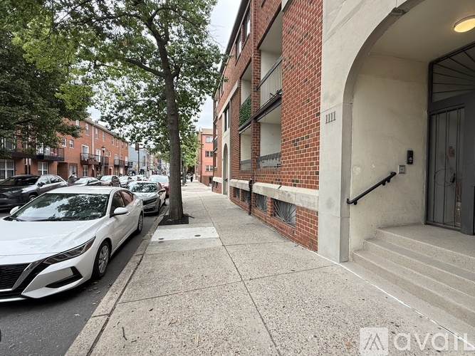 A white car is parked on the side of a street.