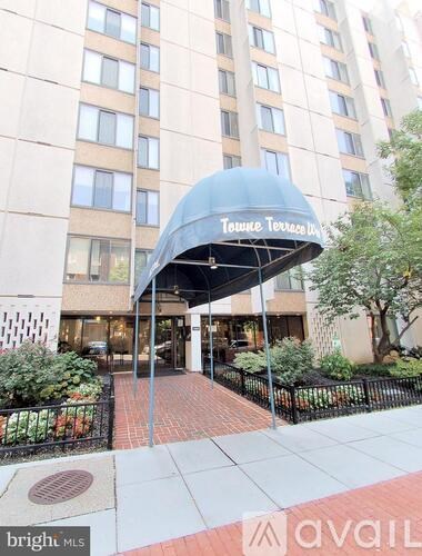 The entrance to Towne Terrace Apartments is covered by a blue awning.